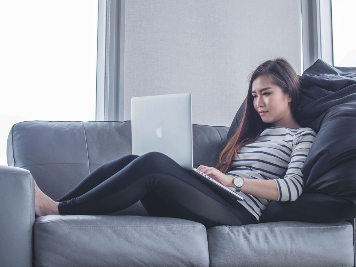 woman is on couch working from home